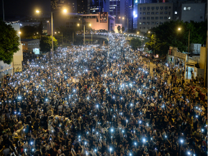  Pro-democracy demonstrators hold up their mobile phones during a protest near the Hong Kong government  headquarters on Sept. 29, 2014. Photo credit: Slate.com